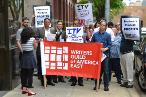 Union members deliver a letter to ITV Studios urging them to make a deal with the WGAE (ITV staffer at far left, in red shoes).